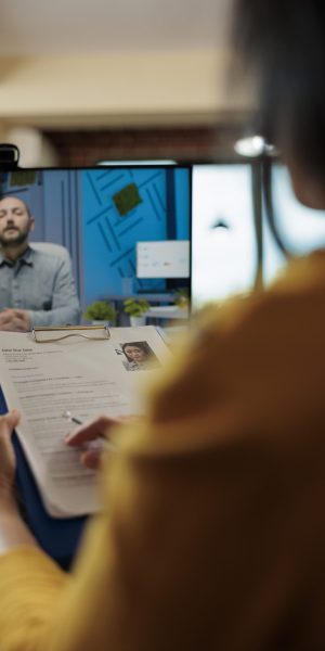 Businesswoman analyzing candidate cv discussing hiring cv with remote man during online videocall meeting. Businesspeople working at company strategy discussing partnership in startup office